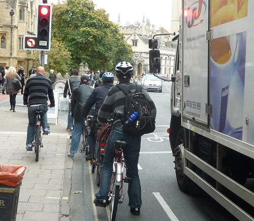 Waiting at Lights (well most do, but, there's often one who will ride on pavement and go through red lights, which is quite dangerous at this junction